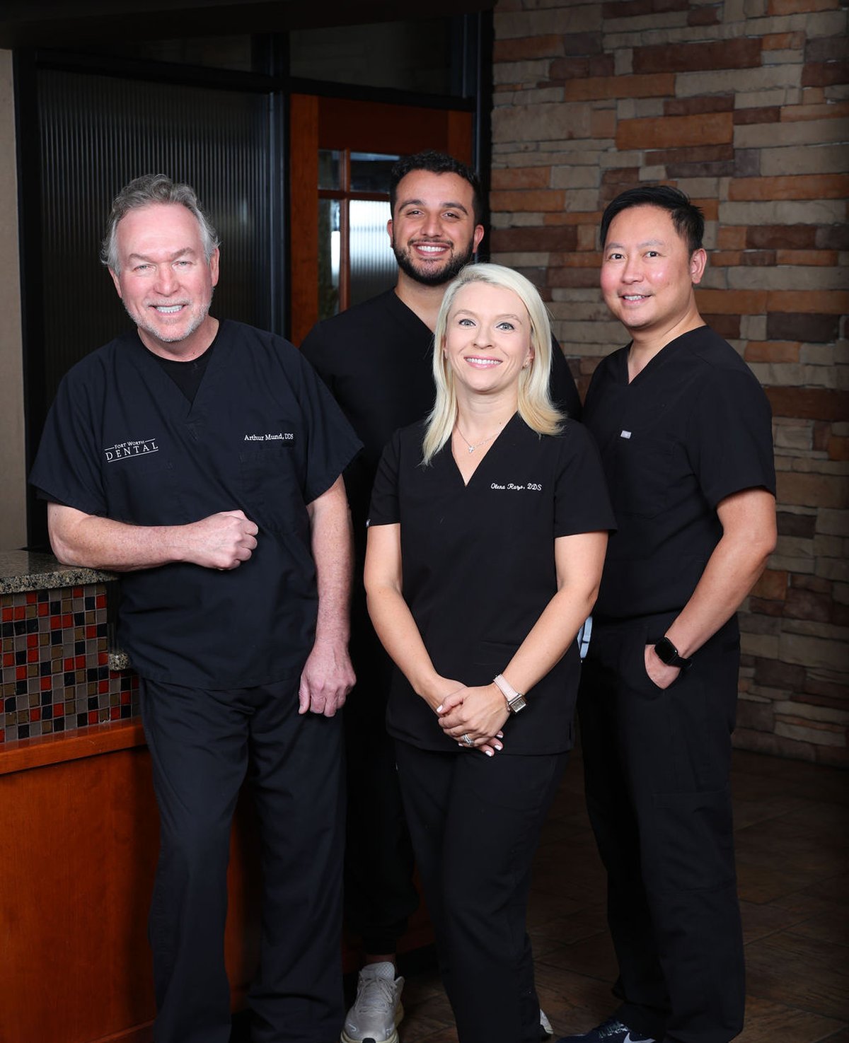 Fort Worth Dental team photo - Dr. Mund, Dr. Razo, Dr. Hiwiadi, Dr. Joshua Pham and dental hygienists at our Fort Worth TX office